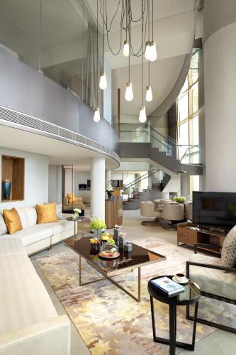 a living room with a couch and a table at Jumeirah Guangzhou - Complimentary Shuttle Bus to Canton Fair Complex in Guangzhou