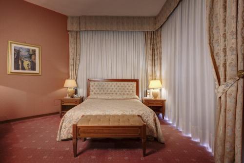 Säng eller sängar i ett rum på Borgo Palace Hotel