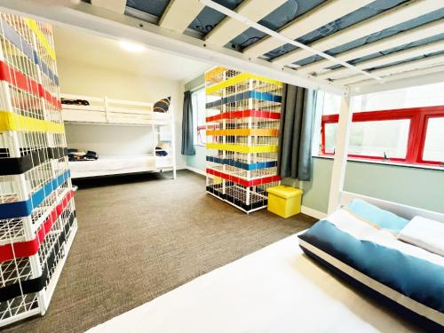 a dorm room with bunk beds and a bed at United Auckland in Auckland