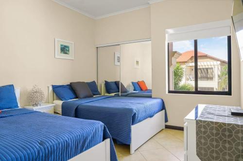 a bedroom with two beds and a window at wonder apartment in gold coast with private pool in Palm-Eagle Beach