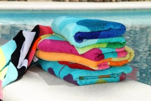 a pile of towels sitting next to a swimming pool at wonder apartment in gold coast with private pool in Palm-Eagle Beach