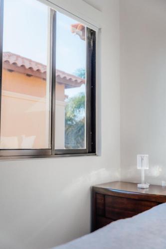 a bedroom with a window and a wooden table at Gold coast elegance with private pool in Noord