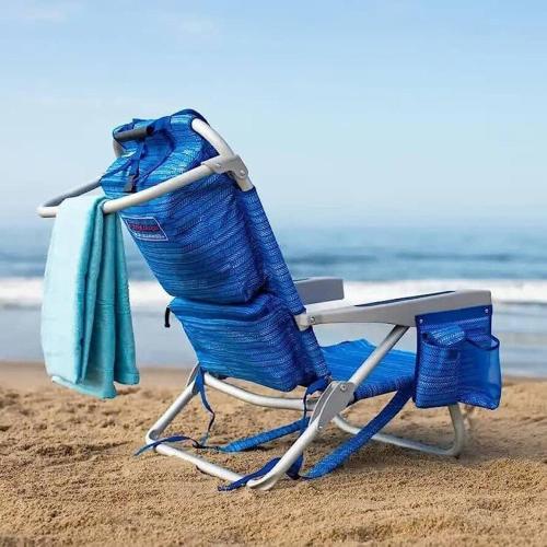 a blue beach chair sitting on the beach at Gold coast elegance with private pool in Noord