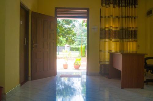 an empty hallway with a door and a window at Yashora Gimanhala in Anuradhapura