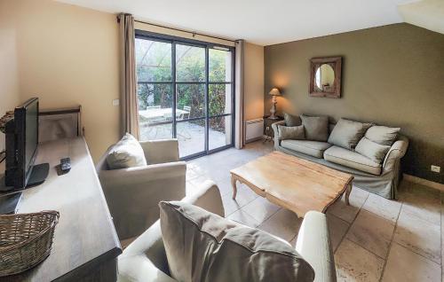 a living room with a couch and a table at Lovely Home In Stlaurent-De-La-Cabr in Saint-Laurent-de-la-Cabrerisse