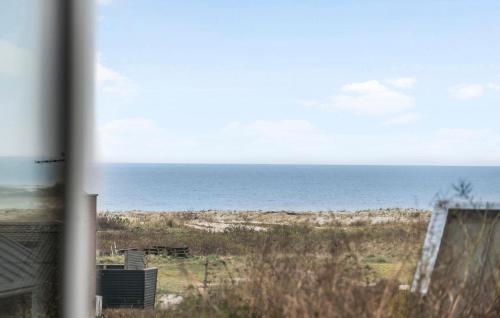 a view of the ocean from a beach at Holiday Home Klintevej Faxe Ladeplads Ii in Fakse Ladeplads