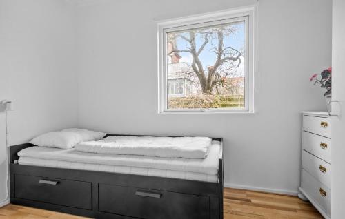 a bed in a room with a window at Holiday Home Klintevej Faxe Ladeplads Ii in Fakse Ladeplads