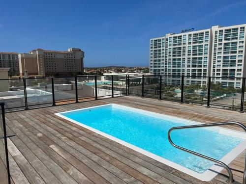 a swimming pool on the roof of a building at Spectacular apartment in palm beach THE COVE in Palm-Eagle Beach
