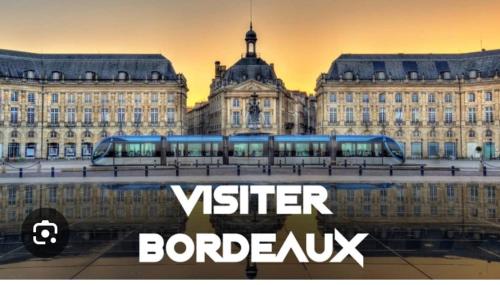 a bus in front of a building with the words visitor bordeaux at Gîte pura vida in Périssac