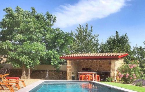 a swimming pool in a yard with a gazebo at La Recre Dempurany in Empurany