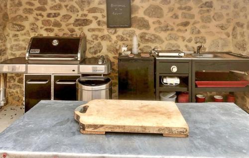 a kitchen with a table with a wooden block on it at La Recre Dempurany in Empurany