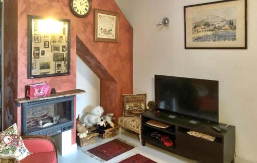 a living room with a television and a fireplace at La Recre Dempurany in Empurany