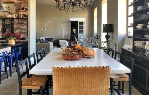 a dining room table with a basket of pumpkins on it at La Recre Dempurany in Empurany