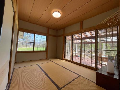 a large room withwindows and a room with a room with a room at Kitakaruizawa Morino Bessou NO7 in Kita-karuizawa