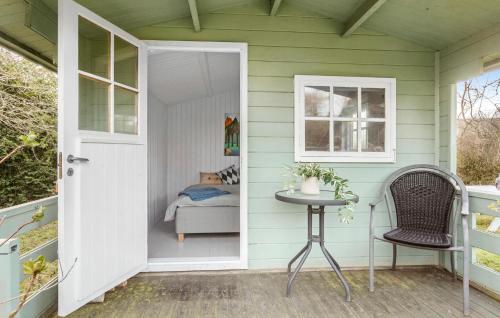 a front door of a house with a table and a chair at 3 Bedroom Cozy Home In Mern in Mern