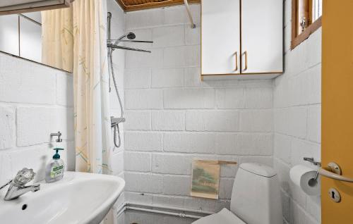 a white bathroom with a sink and a toilet at Nice Home In Rudkbing With Wifi in Spodsbjerg