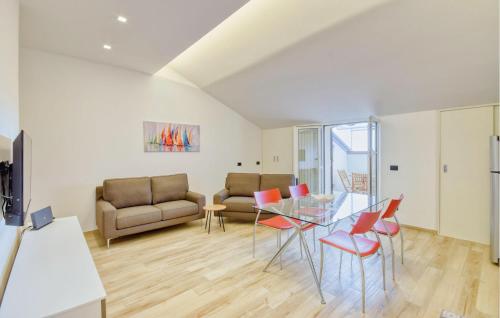 a living room with a glass table and chairs at 2 Bedroom Amazing Apartment In Moneglia in Moneglia