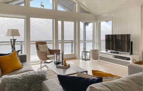 a living room with a couch and a tv at Lovely Home In Valldal in Valldal