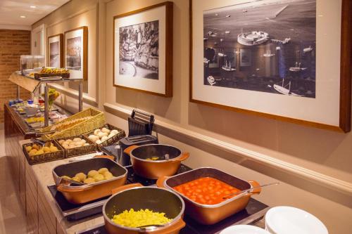 a buffet line with many different types of food at Intercity Salvador Aeroporto in Lauro de Freitas