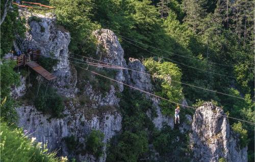 a person walking on a suspension bridge over a mountain at Villa Cami in Gržići