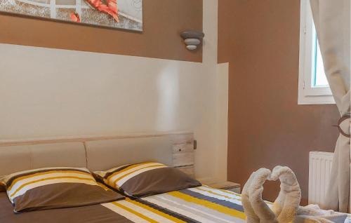 a bedroom with a bed with two pillows at Lovely Home In Pordic in Pordic