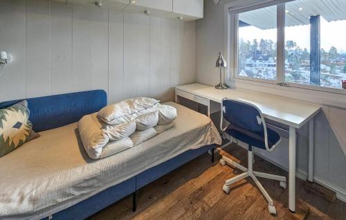 a room with a bed and a desk and a chair at Awesome Home In Sandvika With House A Panoramic View in Sandvika