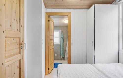 a small bedroom with a bed and a closet at 3 Bedroom Awesome Home In Dannemare in Dannemare