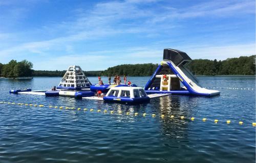 two inflatable boats in the water on a lake at Cozy Ship In Zlocieniec With Lake View in Złocieniec