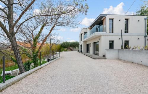 an empty driveway in front of a white house at 3 Bedroom Amazing Home In Allauch in Allauch