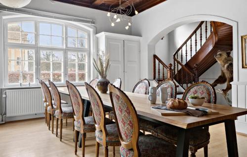 a dining room with a wooden table and chairs at 5 Bedroom Cozy Home In Næstved in Næstved