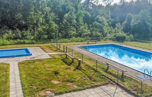 a swimming pool in the middle of a yard at 3 Bedroom Beautiful Home In Hörby in Hörby