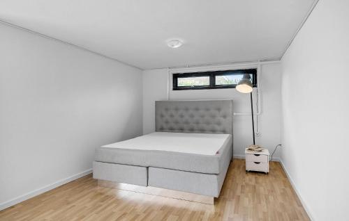 a white bedroom with a bed and a window at Amazing Home In Korsr With House Sea View in Korsør