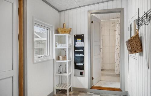 a hallway with white walls and a door with shelves at Stunning Home In Brkop With Wifi in Børkop
