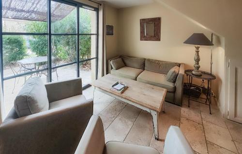 a living room with a couch and a table at Nice Home In Saint-Laurent-De-La-Ca in Saint-Laurent-de-la-Cabrerisse