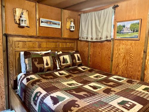 a bedroom with a bed in a wooden room at Mt Rainier Little Green Cabin On Big Creek! in Ashford