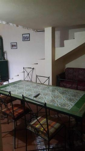 a room with a table and chairs and a couch at Dar Rita in Houmt Souk