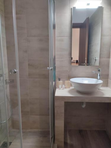 a bathroom with a sink and a shower at ANATOLI ROOMS SERIFOS in Serifos Chora