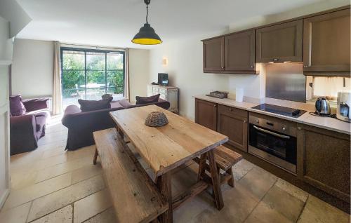 a kitchen and living room with a wooden table at Lovely Home In Saint-Laurent-De-La-Cabrerisse in Saint-Laurent-de-la-Cabrerisse