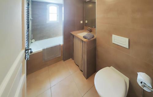 a bathroom with a toilet and a sink at Lovely Home In Saint-Laurent-De-La-Cabrerisse in Saint-Laurent-de-la-Cabrerisse