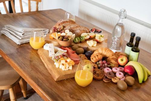 a wooden table with a variety of food and drinks at Treworgie Barton - Duchy in Bude