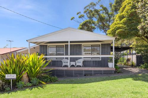 a house with two chairs on the front porch at The Bridge Walk in Manyana