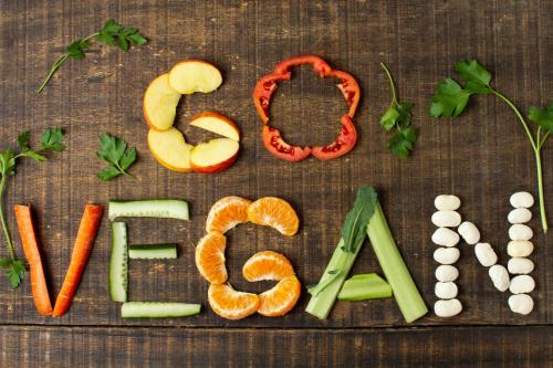 a wooden table with the word food spelled out with vegetables at Feggaropetra Inn Magic Mountain House in Palaios Panteleimon