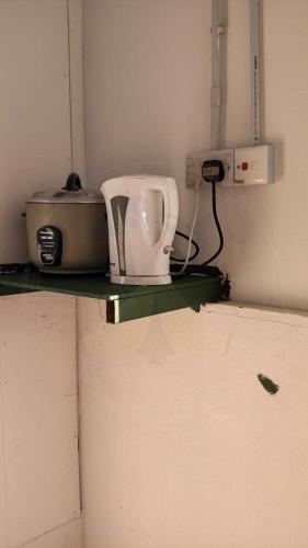 a kitchen counter with a toaster on a shelf at Hawun Valley Kiulu in Tamparuli