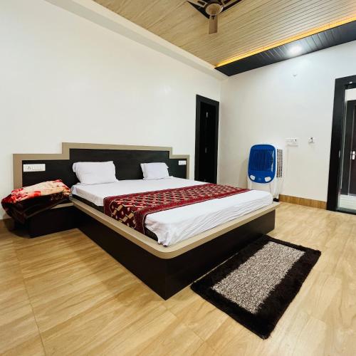 a bedroom with a large bed in a room at Hotel MI Resort in Panna