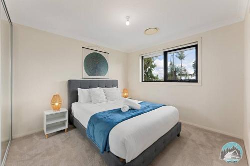 a bedroom with a large bed and a window at Aircabin - Carlingford - Sydney - 4 Beds House in Sydney
