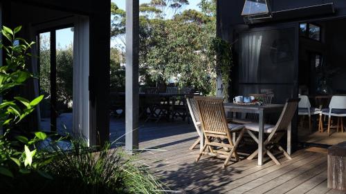 a patio with a table and chairs on a deck at The Getaway in Manyana