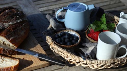 a basket of bread and berries on a table at The Getaway in Manyana