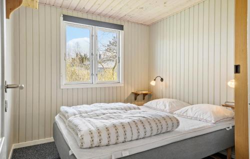 a bedroom with a bed and a window at Beautiful Home In Frvang With Sauna in Fårvang