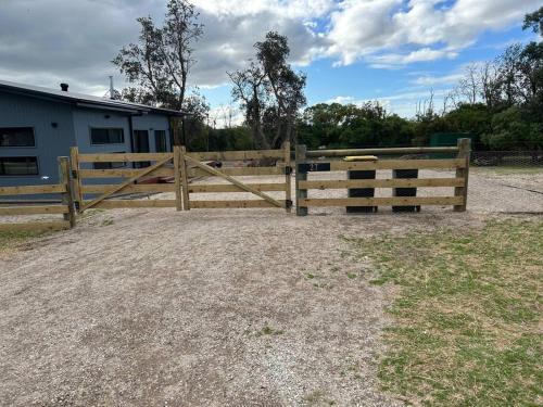 a wooden fence in front of a house at The Bloom in Seaspray