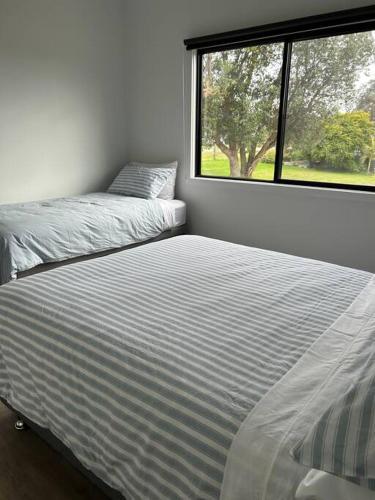 a bedroom with two beds next to a window at The Bloom in Seaspray